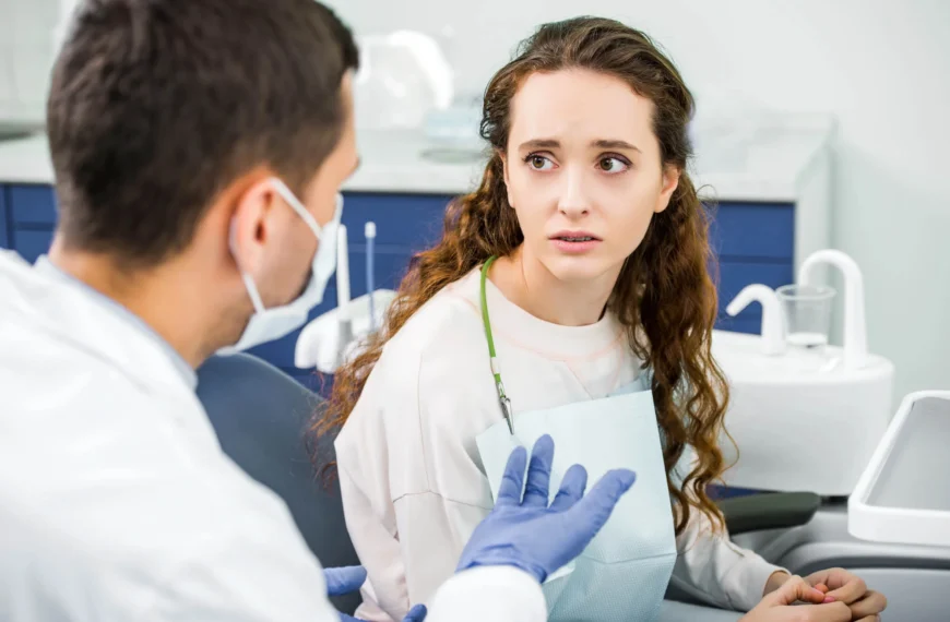 A worried-looking patient is looking at an emergency orthodontist in West Palm Beach