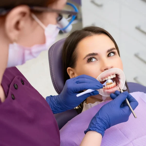 Orthodontists in Forest Hill performing detailed oral exam with dental mirror and tools