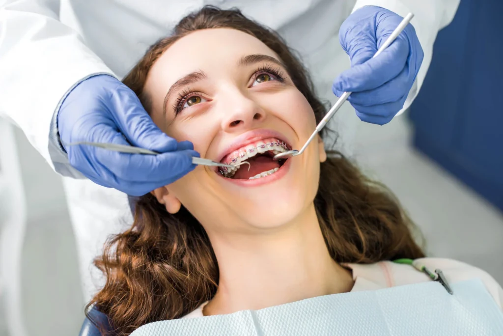 Female teen patient visiting dentist for early orthodontic treatment near you