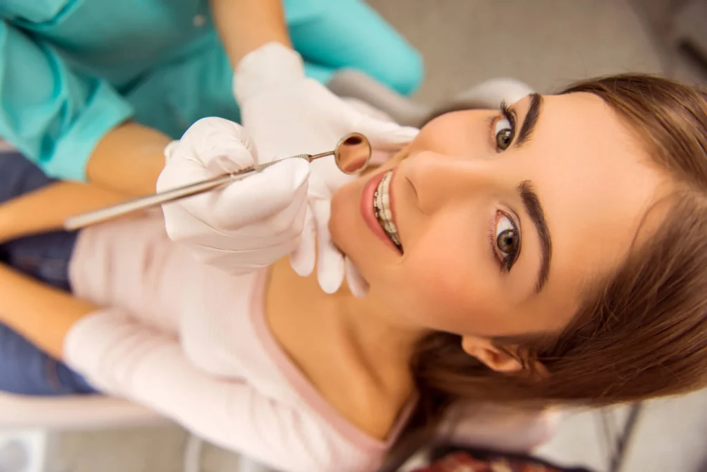 Teen girl at dentist for early orthodontic treatment near you