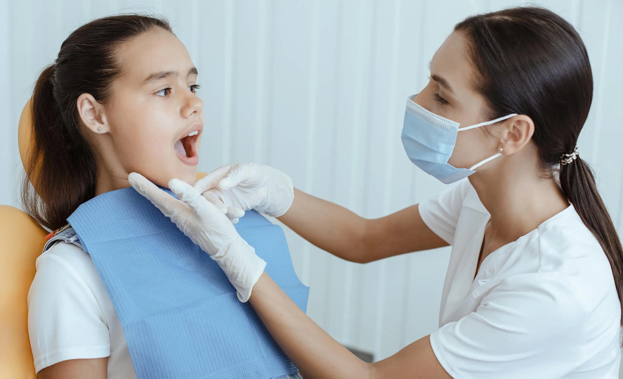Dentist in West Palm Beach examine Invisalign options with patient.