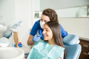 Orthodontist Palm Beach Gardens showing braces to a teen.